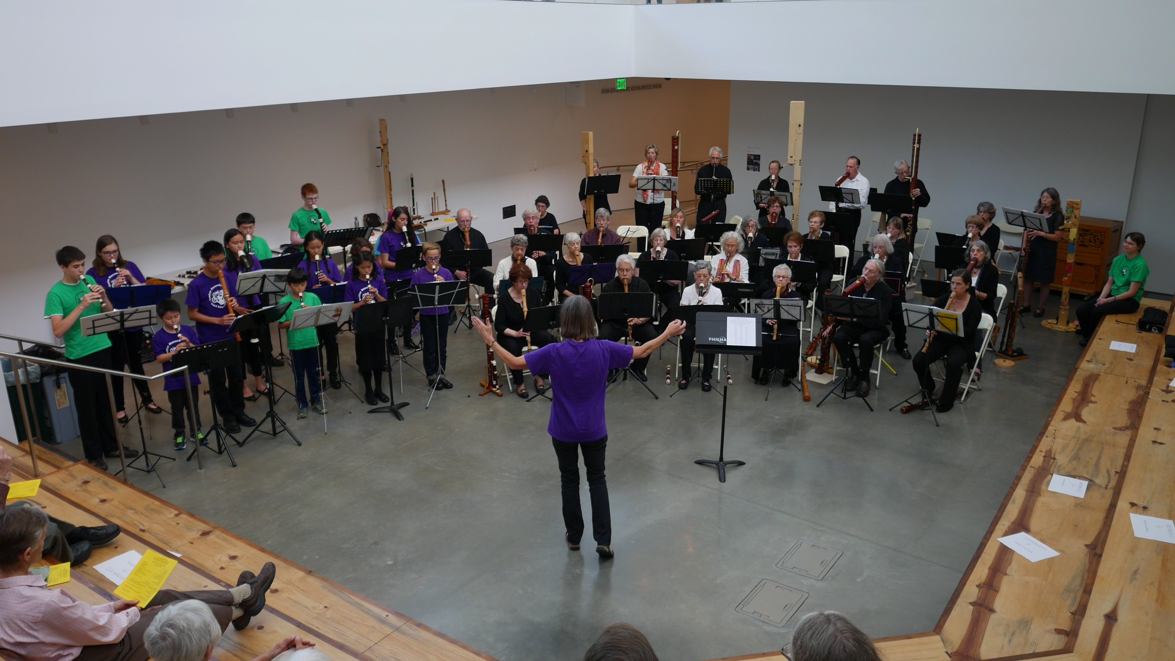 People of many different ages playing recorders together in concert